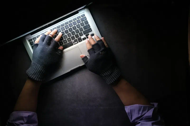hacker typing dark room gloves