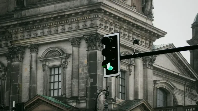 Green traffic light in front of a historic urban building