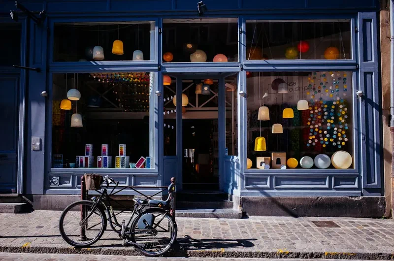 Colorful lighting display in a storefront with a bicycle parked outside