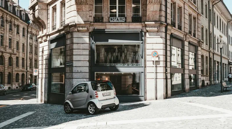 Notary office located on a modern urban street corner with compact car parked outside
