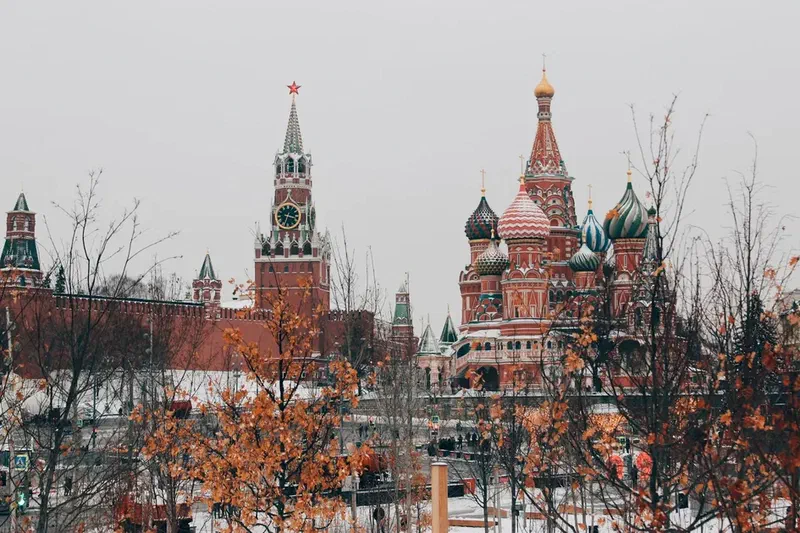 Saint Basil's Cathedral and the Kremlin's Spasskaya Tower in Moscow, Russia, during late autumn.